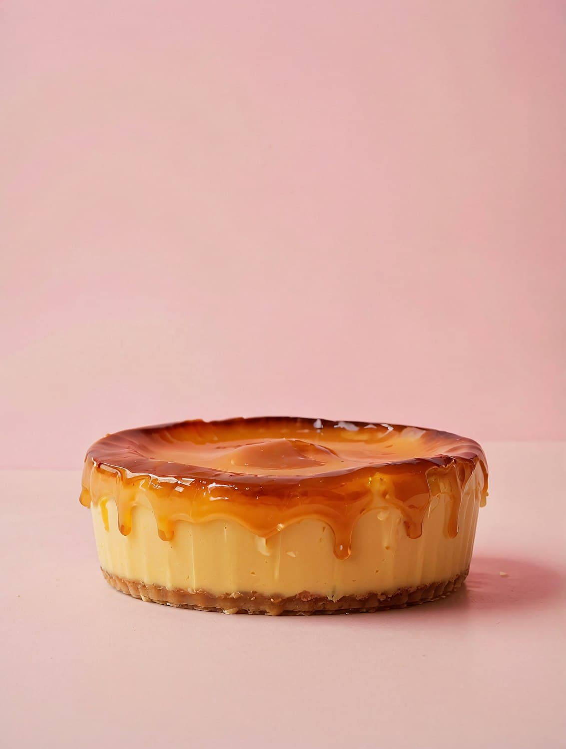 A whole baked cheesecake glazed with caramel